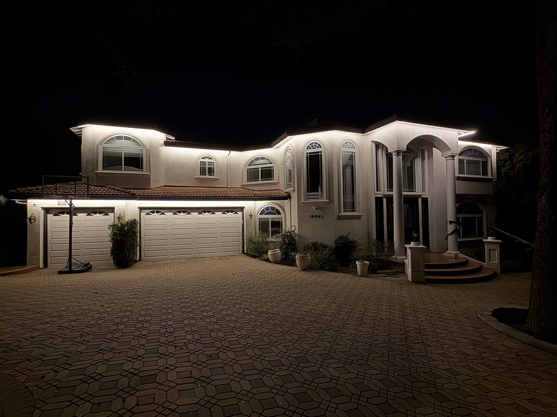 Outdoor deck with smart permanent lighting at night