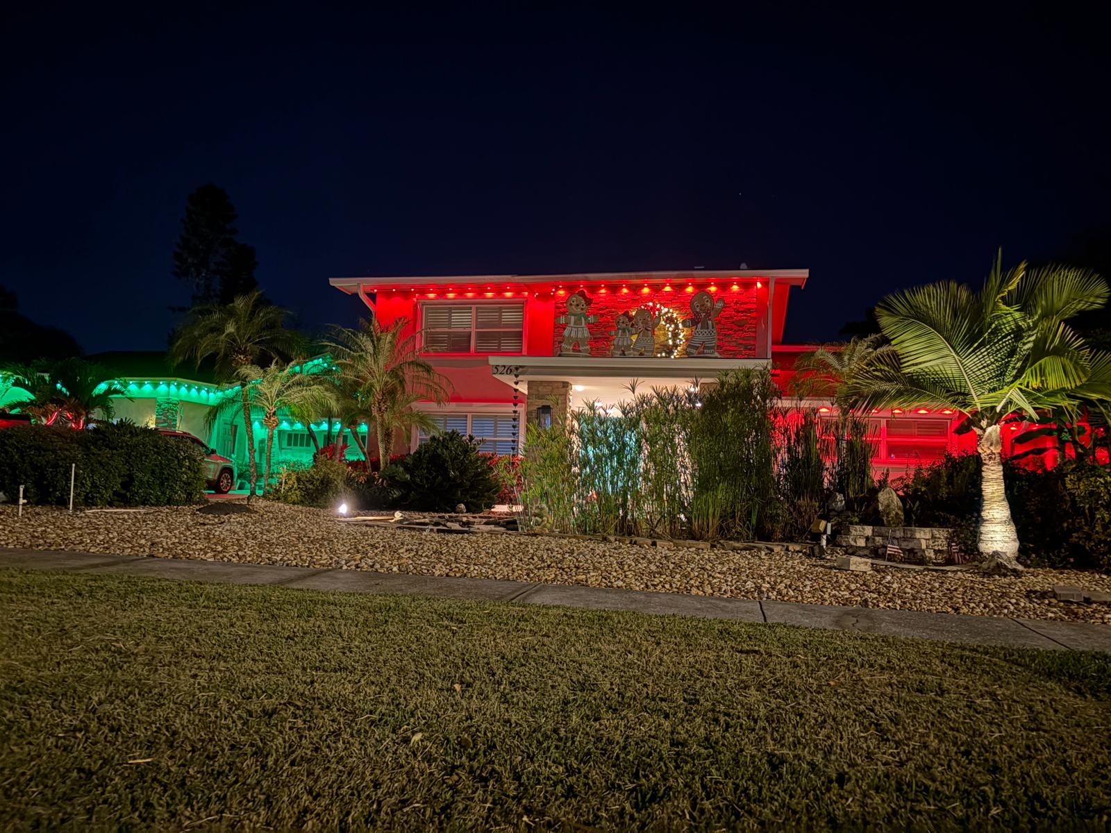 Modern two-story home with red and green holiday RGB lighting