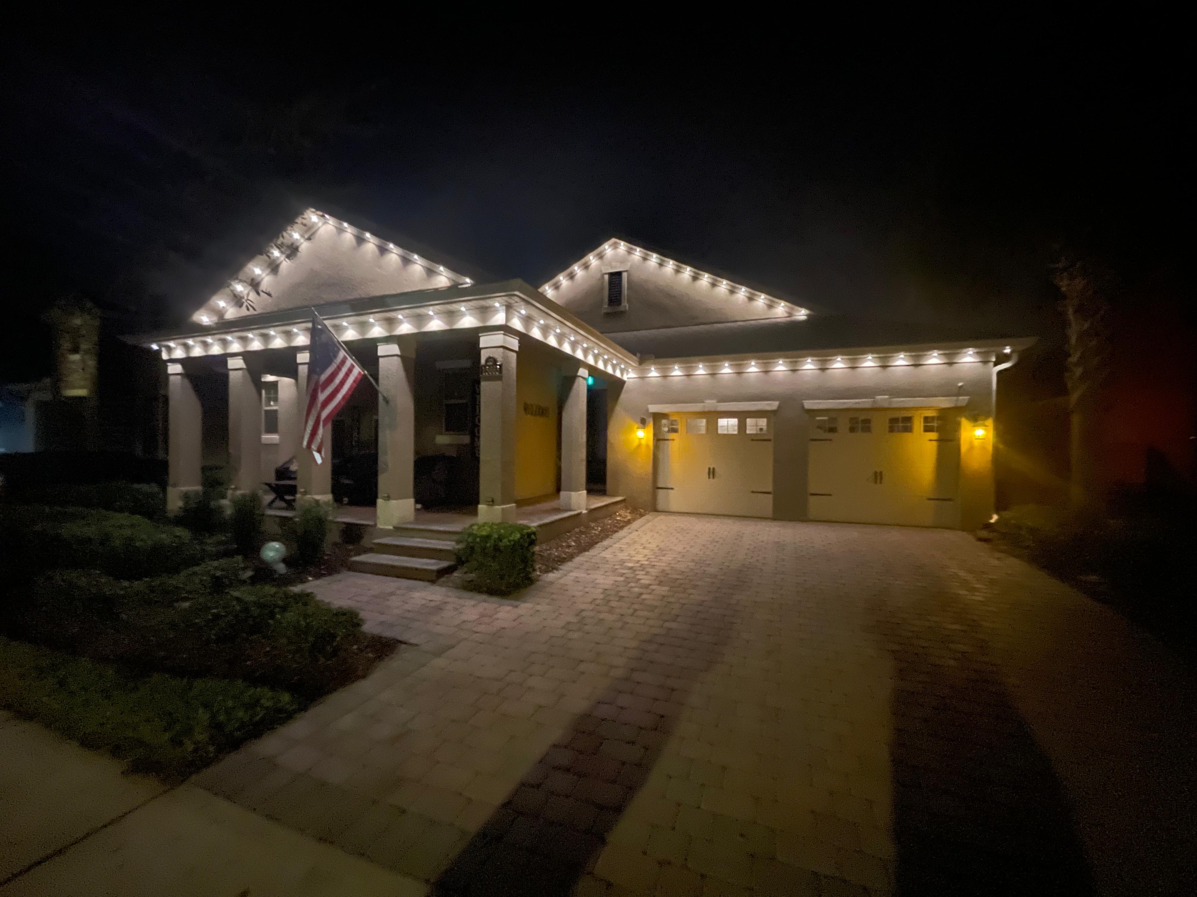Elegant warm white permanent lighting along all rooflines and eaves