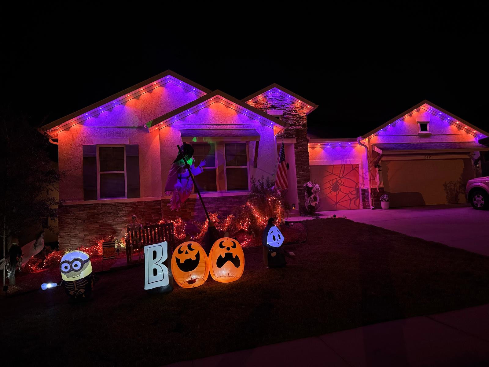 Home with purple and orange Halloween lighting and decorations