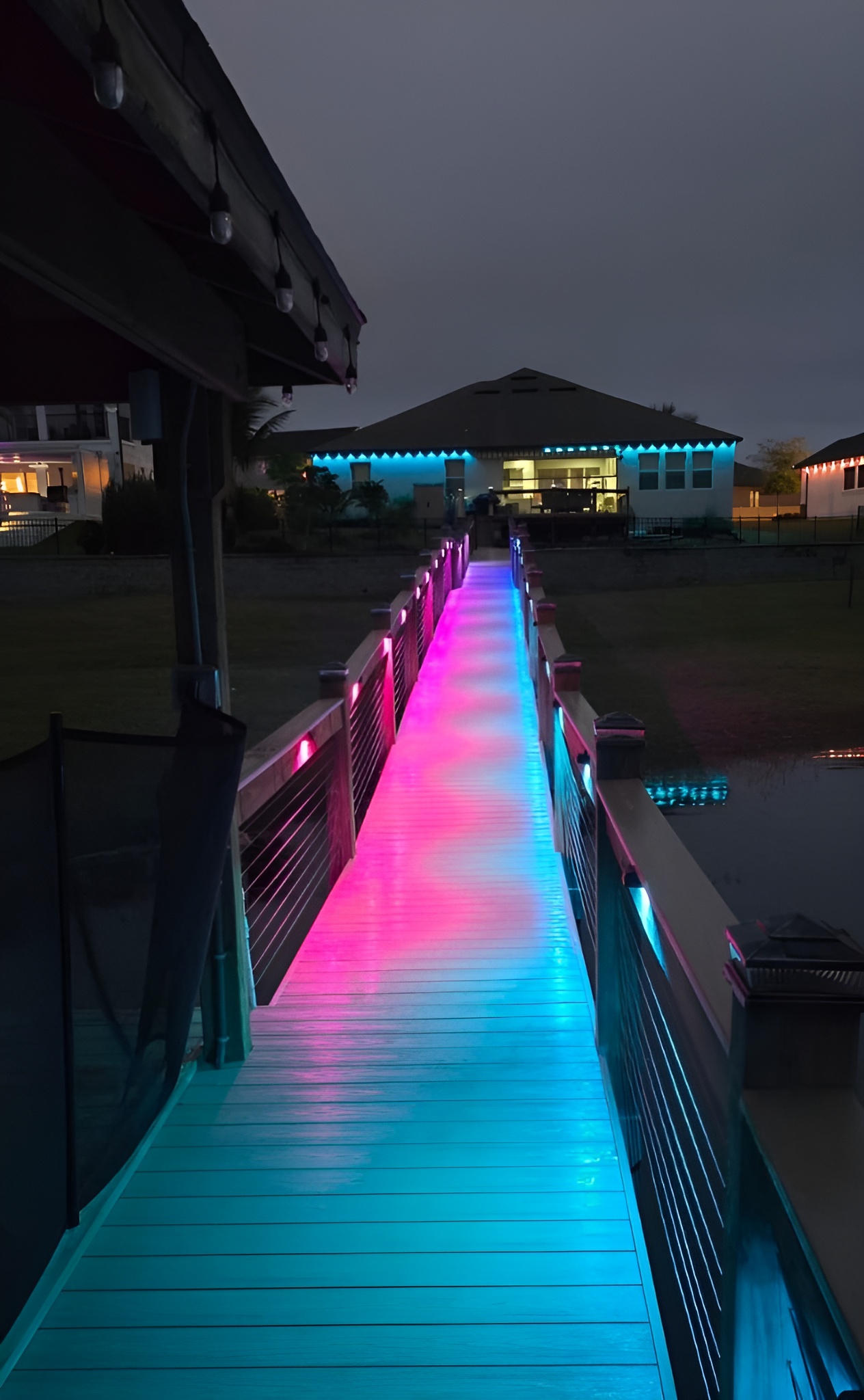 Waterfront dock with RGB deck lighting showing cyan to pink gradient