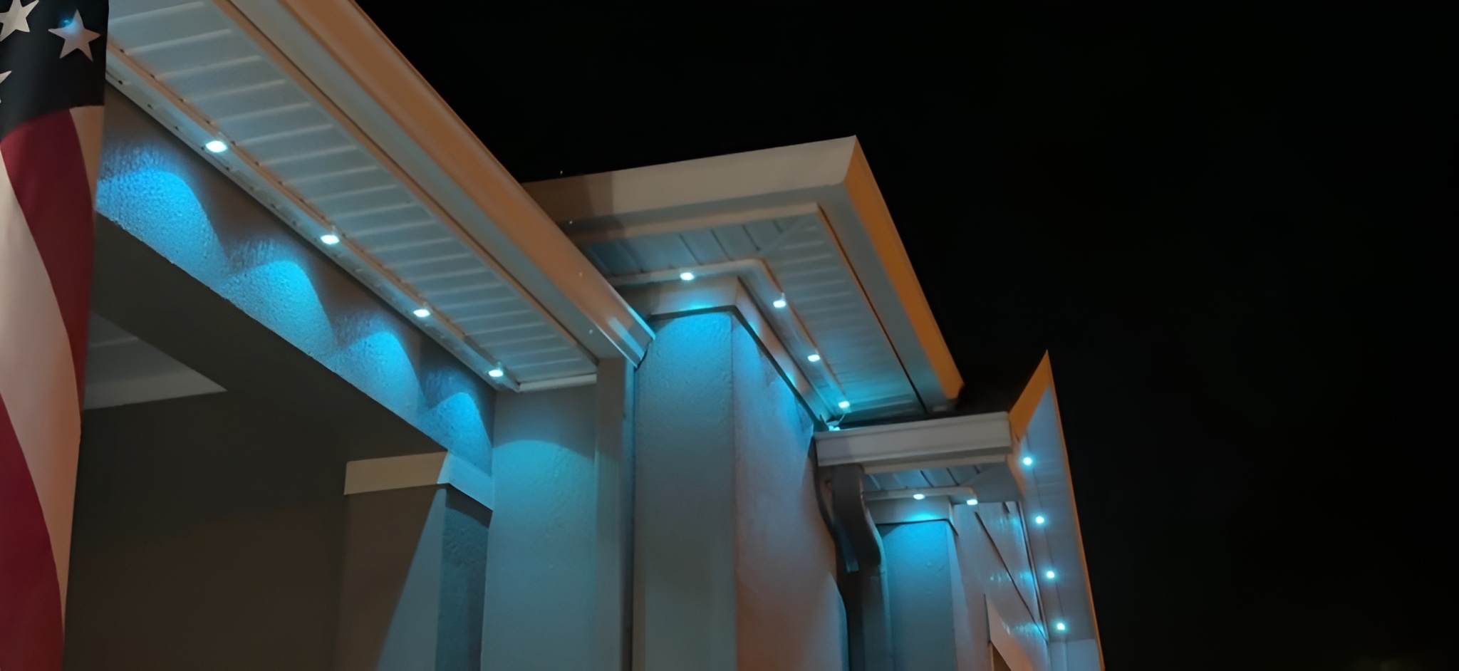 Modern building exterior with cyan PermTrack LED lighting along roofline